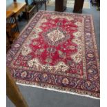 A North West Persian red ground carpet 290cm x 246cm.
