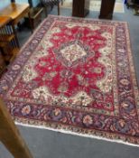 A North West Persian red ground carpet 290cm x 246cm.