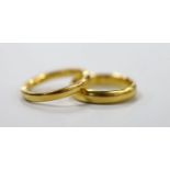 Two 22ct gold wedding bands, the larger hallmarked for Birmingham, 1924, 10.4 grams.
