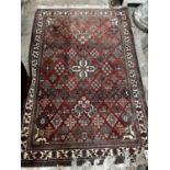 A North West Persian red ground rug, 170 x 116cm