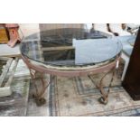 A wrought iron glass topped circular cartwheel garden table, diameter 124cm, height 72cm