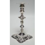 A George III cast silver taper stick, with turned knopped stem and engraved crest, maker, JH,