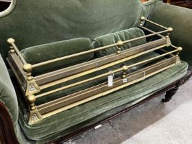 A pair of Victorian style telescopic brass fenders