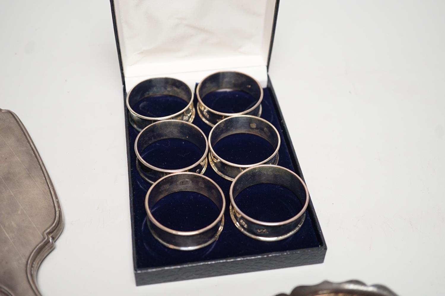 A set of six modern silver napkin rings, a George V silver sauceboat and a silver mounted hand - Image 3 of 5