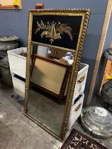 A Regency painted gilt and gesso pier glass with musical trophy tablet, width 62cm, height 124cm