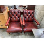A pair of Victorian style button back burgundy leather Howard style open armchairs, width 69cm,