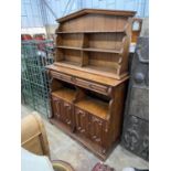 An Arts and Crafts pine buffet with arched top, width 150cm, depth 46cm, height 205cm