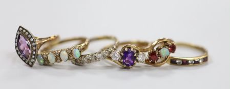 Six assorted modern 9ct and gem set rings, including an amethyst and diamond set three stone