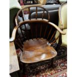 An early 20th century Windsor ash and elm comb back elbow chair, width 66cm, depth 41cm, height
