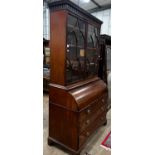 A George III mahogany cylinder bureau bookcase with glazed panelled doors, width 115cm, depth