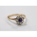 A yellow metal, sapphire and diamond set cluster ring, size N, gross weight 2.2 grams.