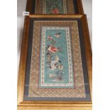 A pair of framed Chinese embroideries with bird and flower decoration, 34 x 14cm