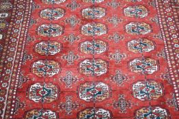 A Bokhara red ground rug, 186 x 122cm