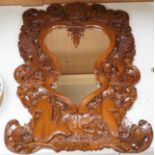 A Balinese carved wood wall mirror, 62cm long