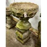 A reconstituted stone circular garden planter on square plinth, diameter 52cm, height 89cm