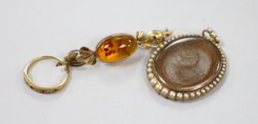 A 19th century yellow metal and split pearl mounted glazed mourning locket pendant containing a lock