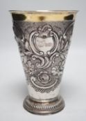 A 19th century Swiss? embossed parcel gilt white metal flared vase, maker's mark AWM, engraved