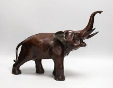 A 20th century patinated bronze model of an elephant, 29cm tall