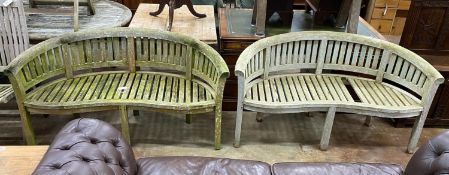 A pair of weathered teak 'banana' garden benches, length 158cm, depth 60cm, height 84cm (one with