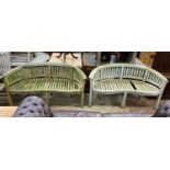 A pair of weathered teak 'banana' garden benches, length 158cm, depth 60cm, height 84cm (one with