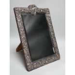 A late Victorian repousse silver mounted rectangular easel mirror, William Comyns, London, 1900,