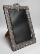 A late Victorian repousse silver mounted rectangular easel mirror, William Comyns, London, 1900,
