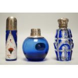 Three assorted silver or white metal mounted glass or porcelain scent bottles, tallest 78mm.