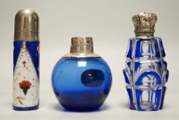 Three assorted silver or white metal mounted glass or porcelain scent bottles, tallest 78mm.