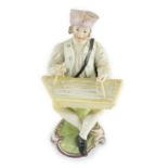 A Frankenthal porcelain figure of a zither player, c.1760, modelled seated on a scrollwork base,