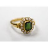 An Edwardian 18ct gold, green tourmaline and split pearl set oval cluster ring, size S, gross weight