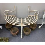 A painted wrought iron garden tree seat, width 120cm, depth 60cm