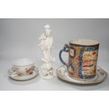 A Chinese figure of blanc de chine, a dragon tea bowl, a saucer, a large tankard, and another