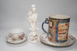 A Chinese figure of blanc de chine, a dragon tea bowl, a saucer, a large tankard, and another