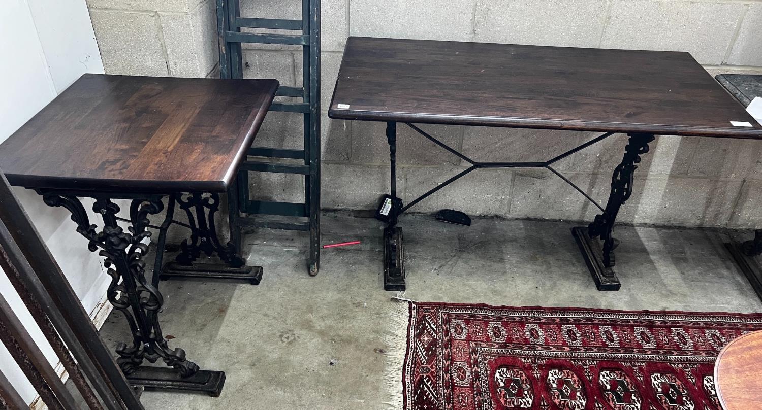 Two Victorian style cast metal stained wood topped tavern tables, larger width 120cm, depth 60cm,