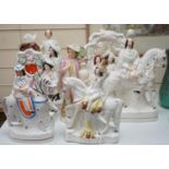 A collection of Victorian Staffordshire pottery flat-back figures and groups, tallest 36cm