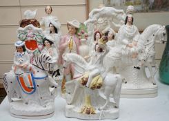 A collection of Victorian Staffordshire pottery flat-back figures and groups, tallest 36cm