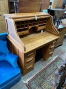 An early 20th century pale oak roll top desk, with 'S' shape tambour, width 121cm, depth 77cm,