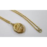A continental engraved yellow metal oval locket, overall 38mm, on a 9ct chain, 47cm, gross weight