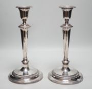 A pair of 1940's silver mounted candlesticks, by Mappin & Webb, height 27.7cm, weighted.