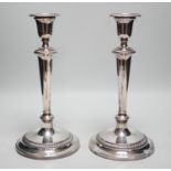 A pair of 1940's silver mounted candlesticks, by Mappin & Webb, height 27.7cm, weighted.