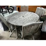 A Jo Alexander circular weathered teak folding garden table, diameter 120cm, height 75cm and four