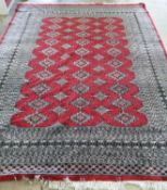 An Afghan red ground carpet, 290 x 210cm