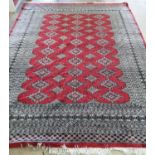 An Afghan red ground carpet, 290 x 210cm