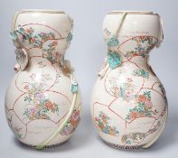 A pair of large late 19th century Satsuma pottery gourd shaped vases, each modelled with a gourd