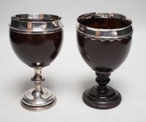 Two late 18th century white metal mounted pedestal coconut cups, one hallmarked silver for John