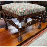 An early 20th century Jacobean revival carved beech dressing stool, length 60cm, depth 48cm,