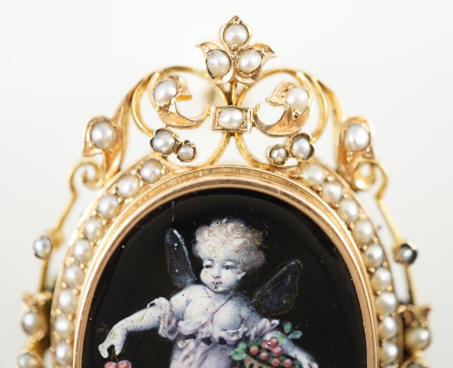 A Victorian oval gold and enamel pendant/brooch, painted with a cherub offering cherries to a - Image 2 of 4