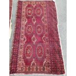 A Tekke burgundy ground rug, 135 x 77cm, worn