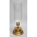 Three matching brass and glass storm lanterns, 49cms high