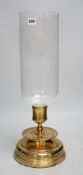 Three matching brass and glass storm lanterns, 49cms high